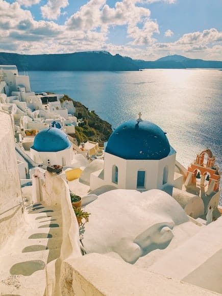 Igrejas brancas com cúpulas azuis em Santorini, Grécia, com vista para o Mar Egeu