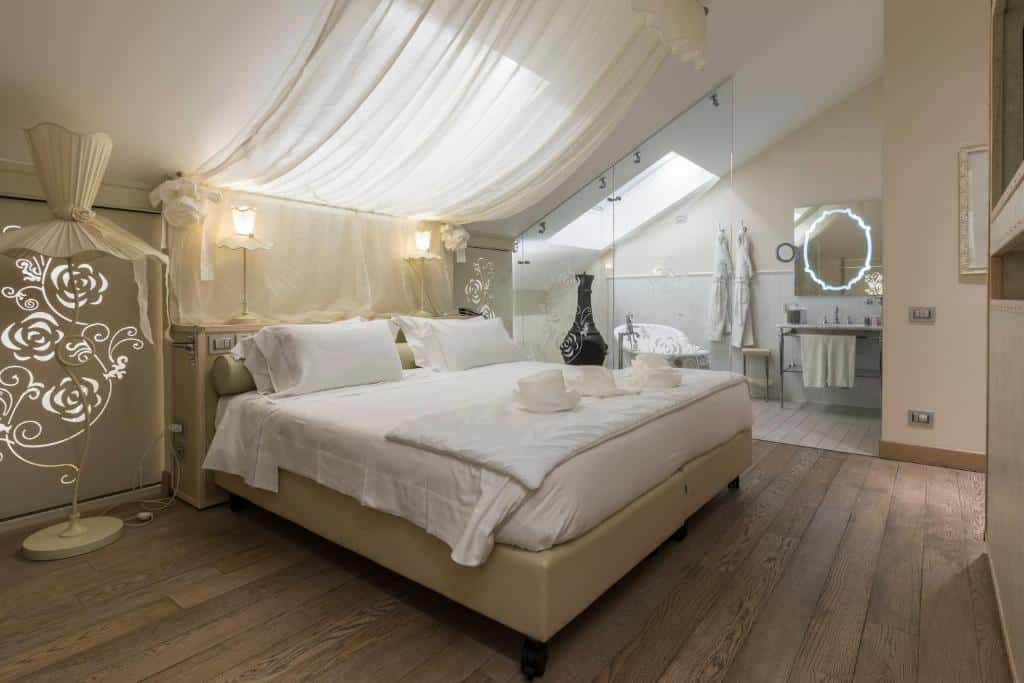 Quarto amplo e elegante, todo em tons de branco, do Château Monfort – Relais & Châteaux