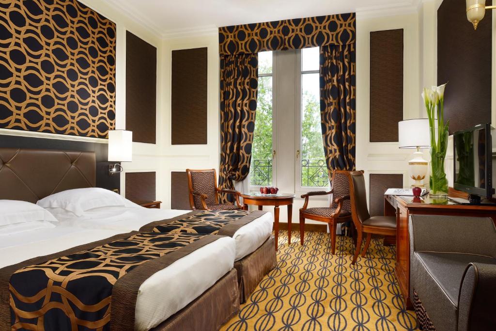 Quarto de decoração trabalhada, com cama de casal, mobiliário em madeira e janela ampla no Grand Visconti Palace