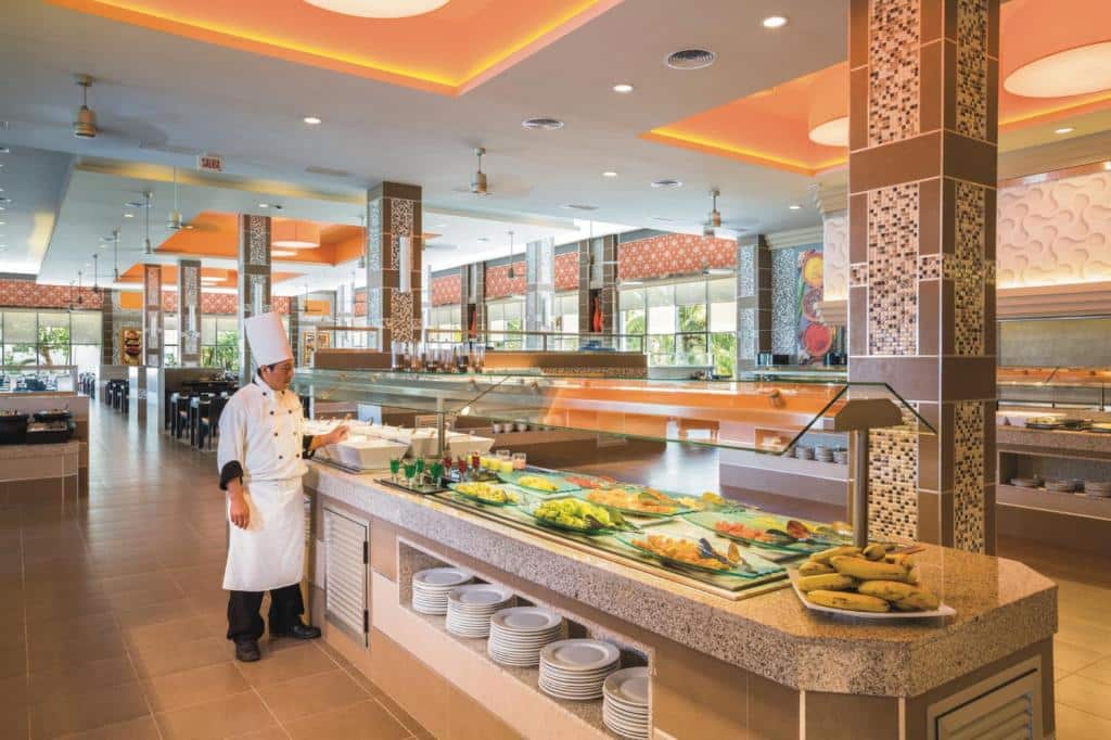 Buffet livre com variedade de saladas, fruta e pratos quentes num restaurante self-service no Riu Playacar – Tudo Incluído.
